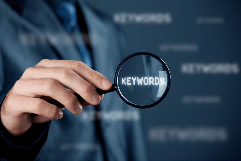 photo of man holding magnifying glass over keywords for advanced seo techniques