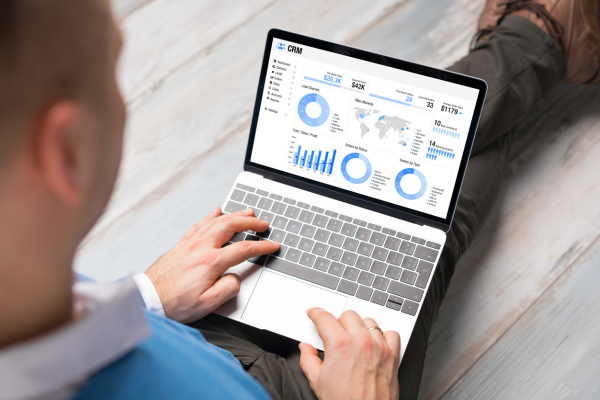 man looking at analytics on laptop after website conversion optimization for a high converting website